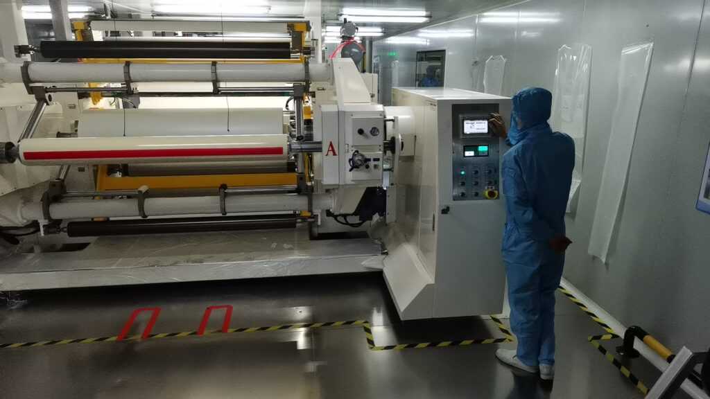dyed carbon and ceramic window tint rolls stocked on racks in the KSB window film plant